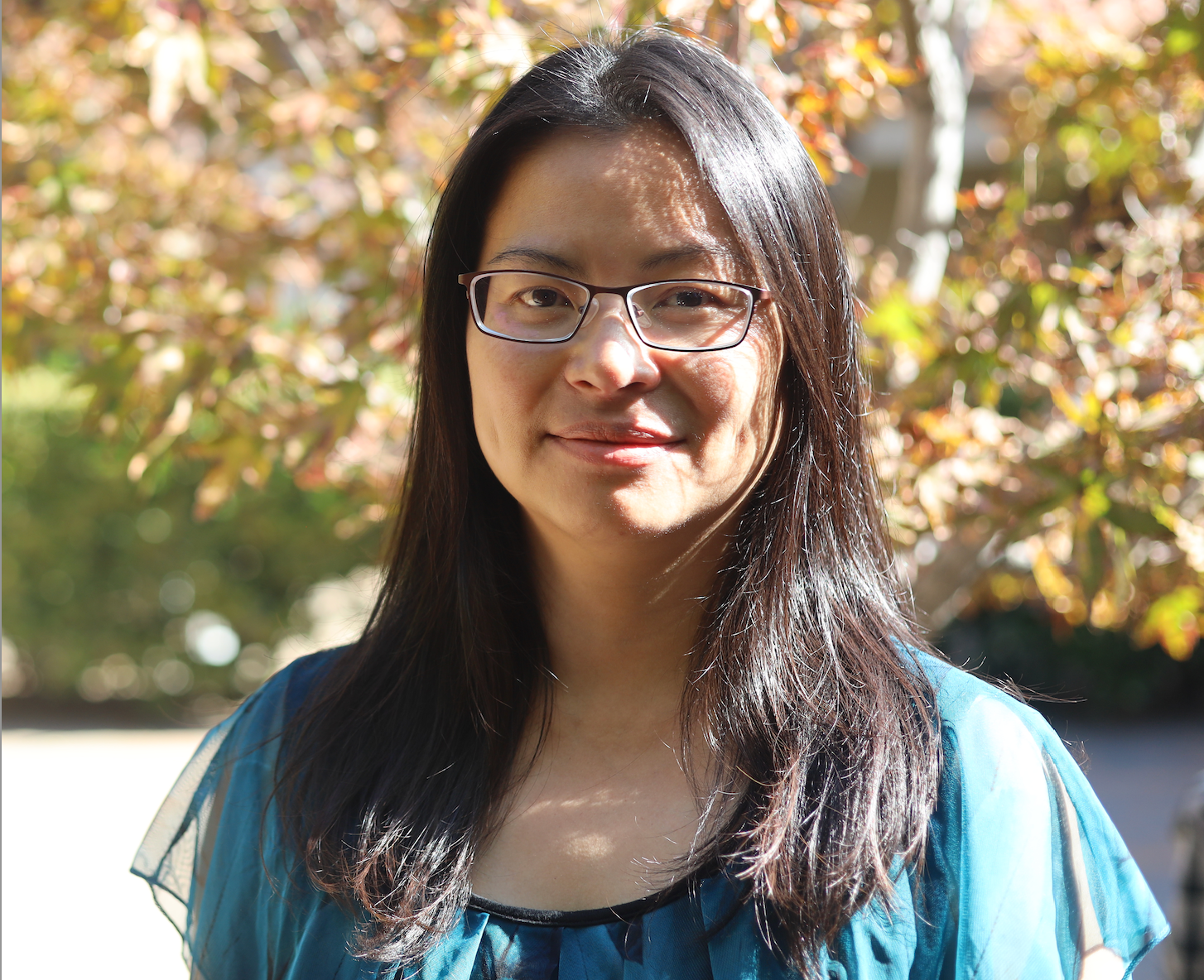 photo of pei tzu leaning on tree